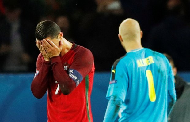 Cristiano Ronaldo reacts after his spot kick hits the post against Austria