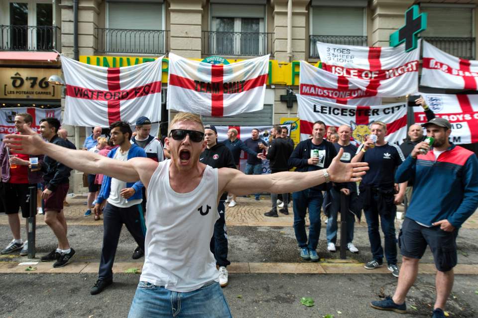 An England's supporter reacts as he gath