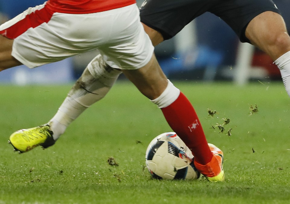 alon Behrami challenges France's Antoine Griezmann resulting in the ball to burst 