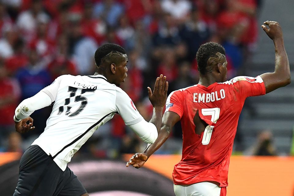 Breel Embolo has his shirt torn to shreds after clashing with Paul Pogba