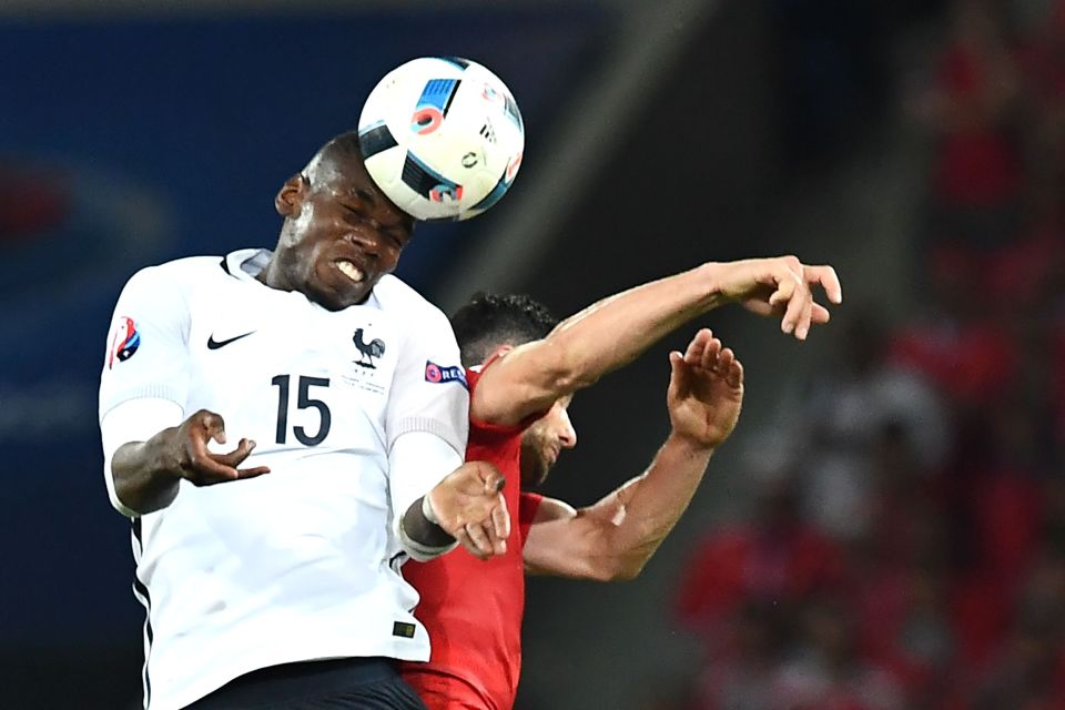 France's midfielder Paul Pogba (L) vies for the ball against Switzerland's defender Fabian Schaer during the Euro 2016 group A football match between Switzerland and France at the Pierre-Mauroy stadium in Lille on June 19, 2016. / AFP PHOTO / FRANCK FIFEFRANCK FIFE/AFP/Getty Images