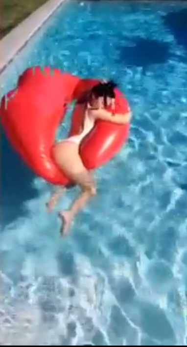  Kylie made a joke about inflatable lips as she lounged in the pool