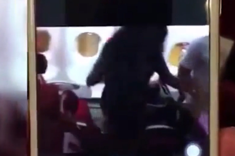  A brawl broke out on a plane in Beijing after a woman tried to hit a member of the cabin crew