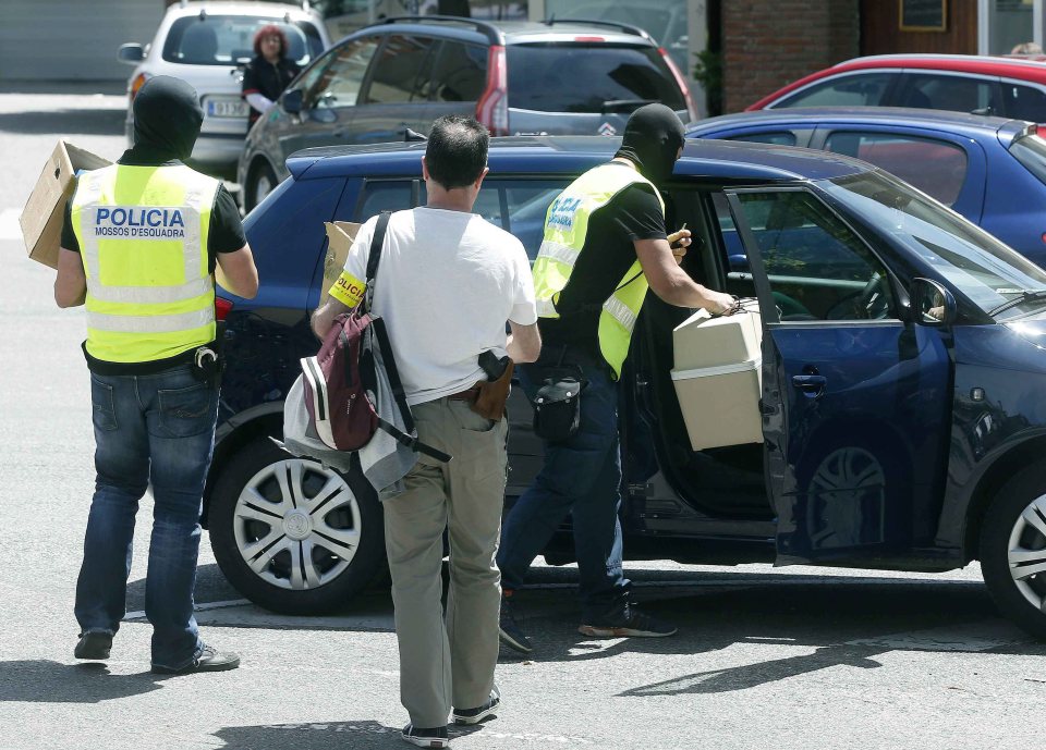 Samples were loaded into a car by police in balaclavas in Sabadell