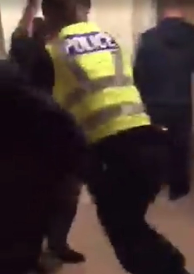 The policeman struggles to escape and take control over the situation