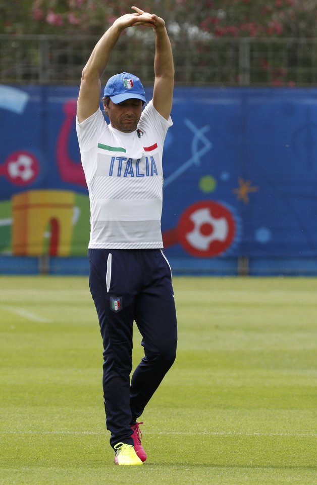 Incoming Chelsea manager Antonio Conte stretches as he takes Italy training