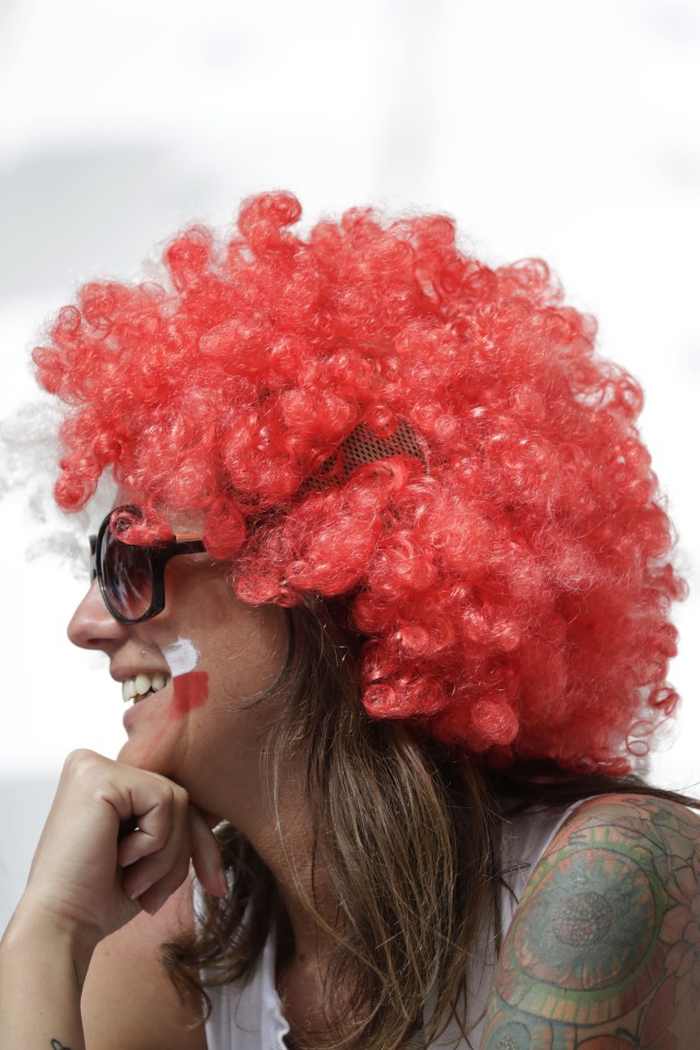  Polish supporter sports a red clown wig and a tattoo on her shoulder