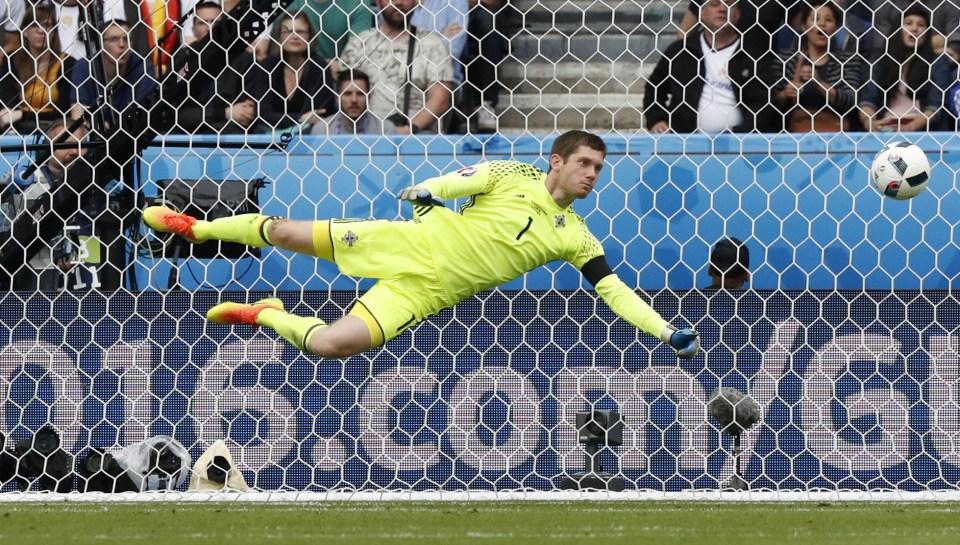  Michael McGovern makes one of his many flying stops against Germany