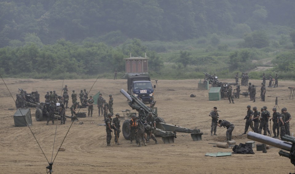  South Korean army soldiers prepare to fire 105mm howitzers during an exercise in Paju, South Korea, near the border with North Korea today