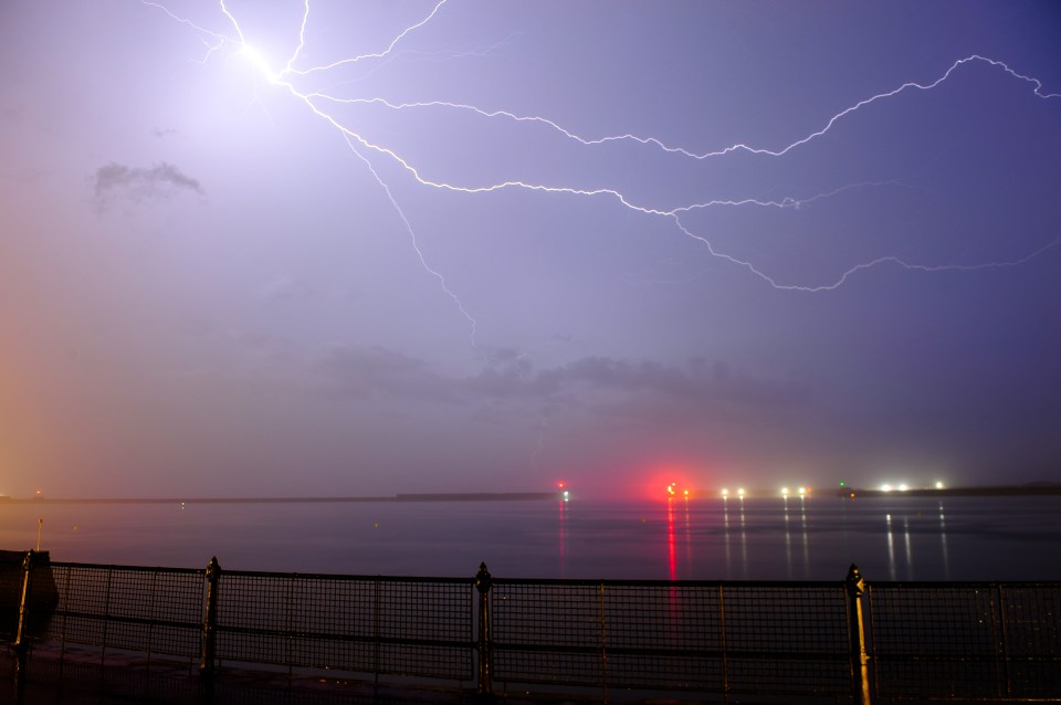  Lightning streaks across the purple sky over Kent as adverse weather hits the UK