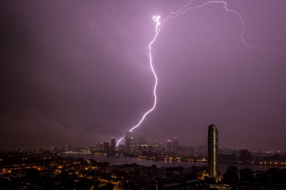  A massive lightning strike over Canary Wharf illuminates the London skyline