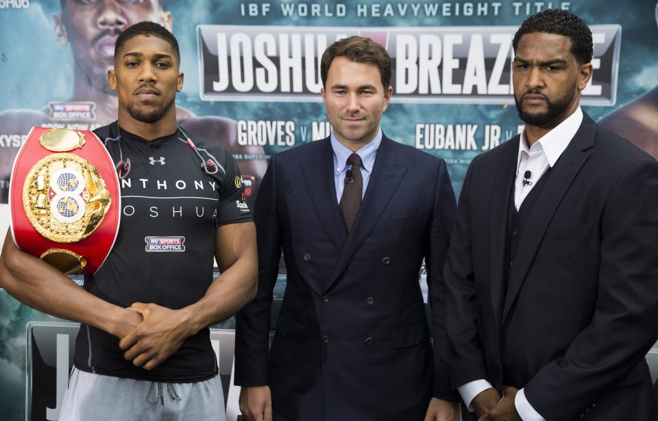 Promoter Eddie Hearn stands in the middle of fighters Anthony Joshua and Dominic Breazeale