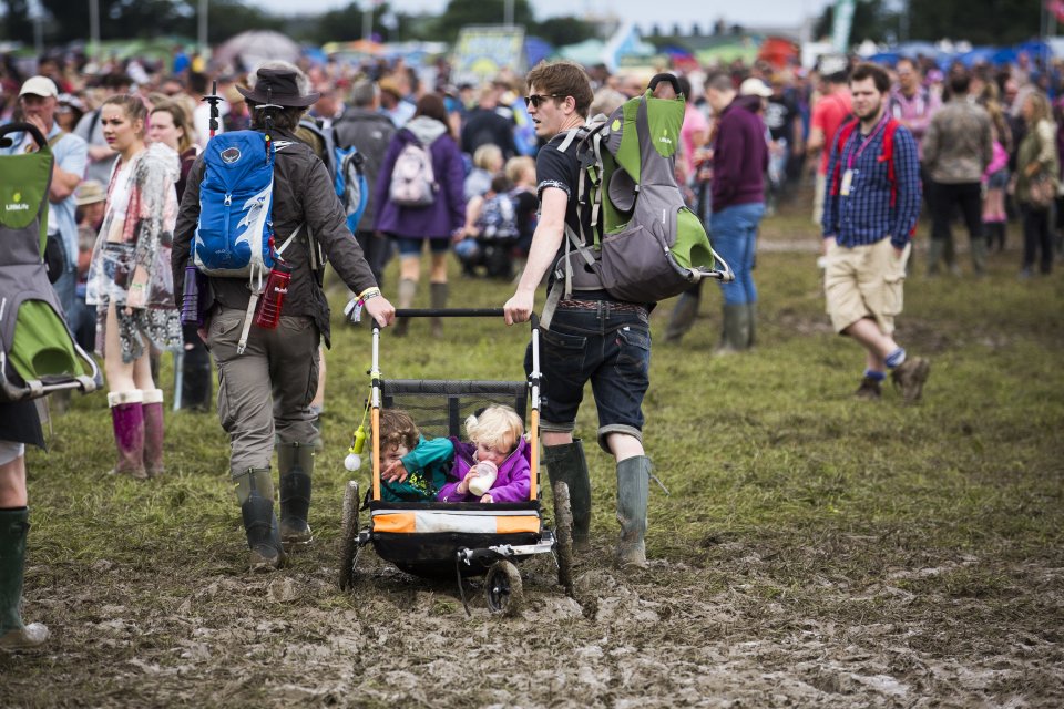  This couple discovered an ingenious way of transporting their young children through the mud with a minimum of fuss