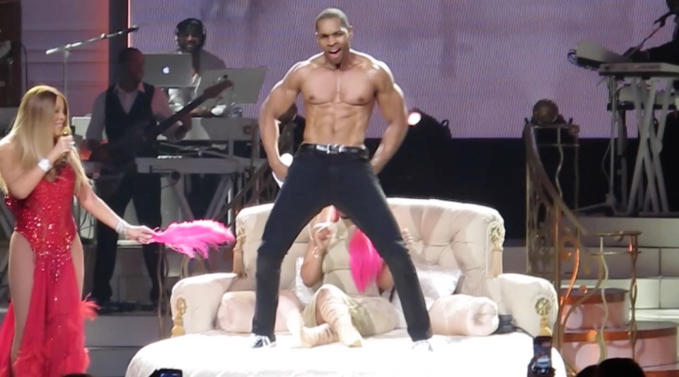  The pop diva's hunky dancer whipped off his top