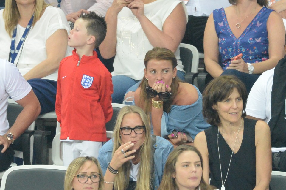 Nail biter . . . Kai Rooney and mum Coleen watch anxiously from stands