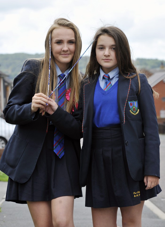 Ellie-Mae Holmes pictured with her sister Lucy (right) was threatened to be chucked out of class for wearing a blue and white braid she got while holidaying in Greece