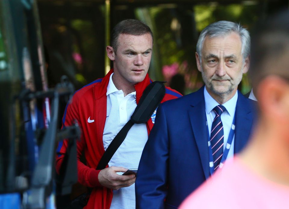 Wayne Rooney looks in pensive mood as he prepares to fly home