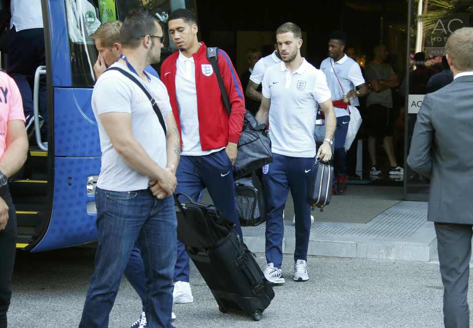 Chris Smalling and Jordan Henderson cut dejected figures as they leave the hotel