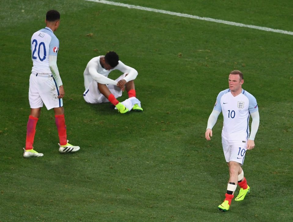 Wayne Rooney walks from the pitch as Dele Alli and Daniel Sturridge show their disappointment after Euro elimination