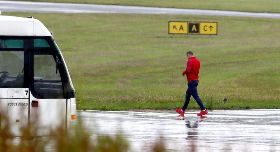 Wayne Rooney leaves Manchester airport after the England squad return