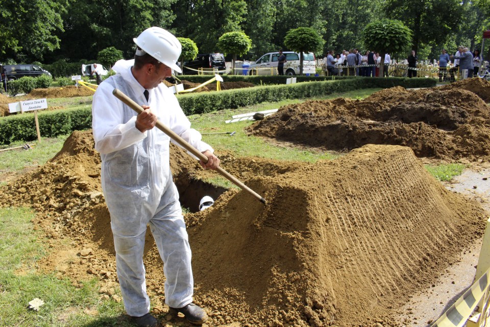  Judges inspect the finished graves after the competition was over