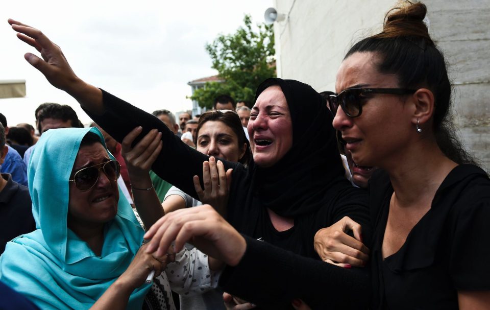  Torment: The daughter (centre) of Siddik Turgan, a man killed in the ISIS massacre, breaks down as her father's coffin is carried during his funeral ceremony in Istanbul