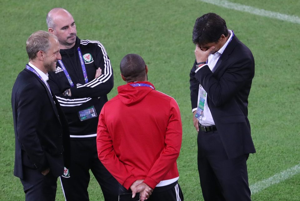 A frustrated Chris Coleman speaks with his backroom staff and captain Ashley Williams