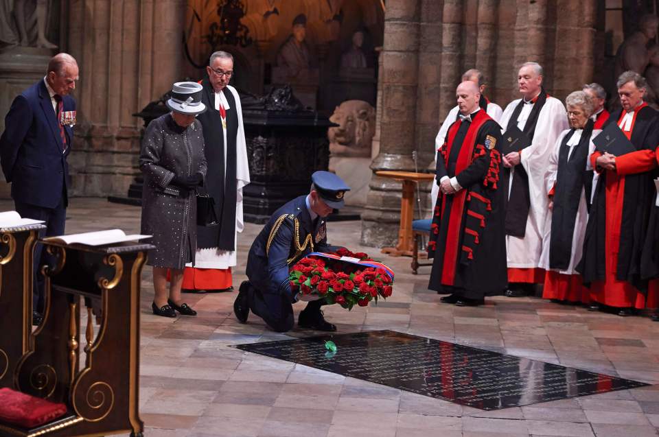  A member of the military lays a wreath made of roses and bay leaves on the Grave of the Unknown Warrior on behalf of the Queen