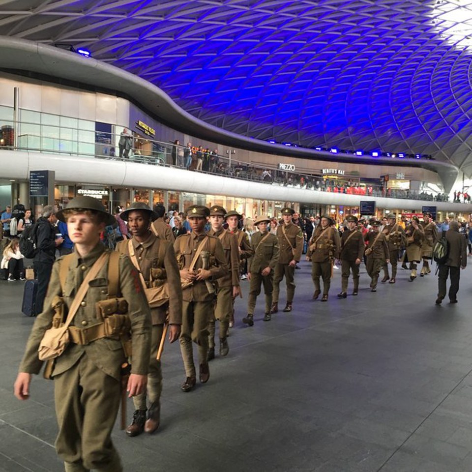  Young men dressed as World War I soldiers walk through King's Cross Station in London