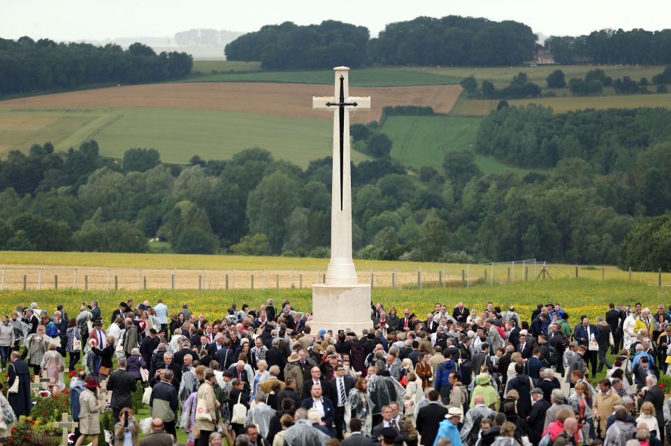  People gather round the Cross of Sacrifice at the scene of the battle