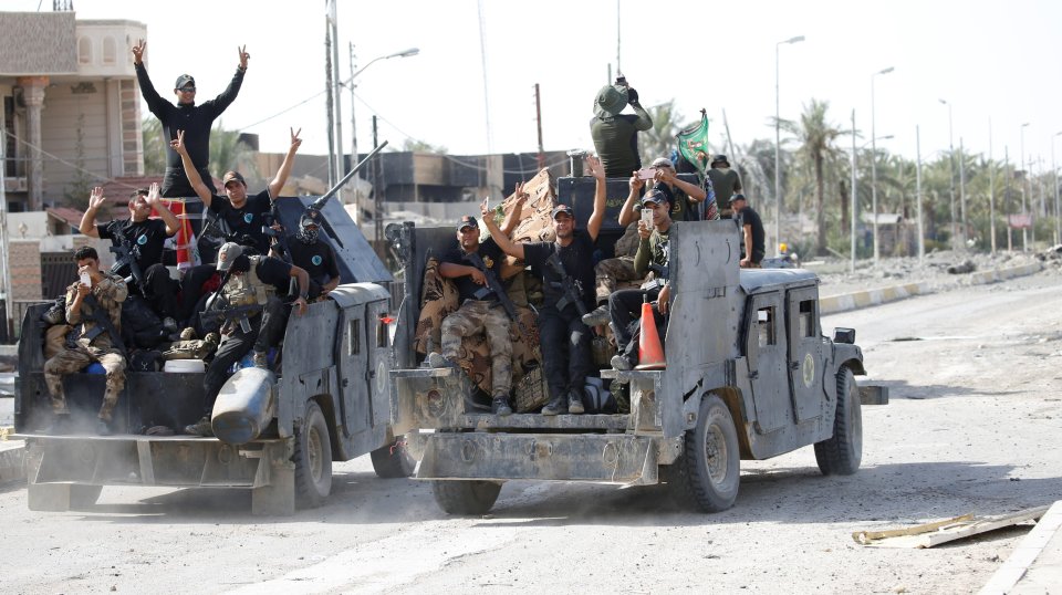 Iraqi counter-terrorism forces gesture in Fallujah after they took back control of the city from ISIS