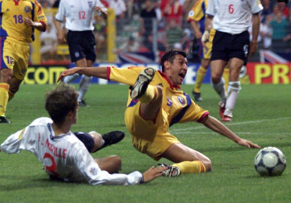  Romania's Viorel Moldovan is fouled by England Phil Neville during Euro 2000