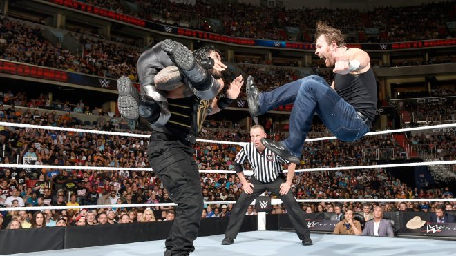 Ambrose dropkicks Reigns