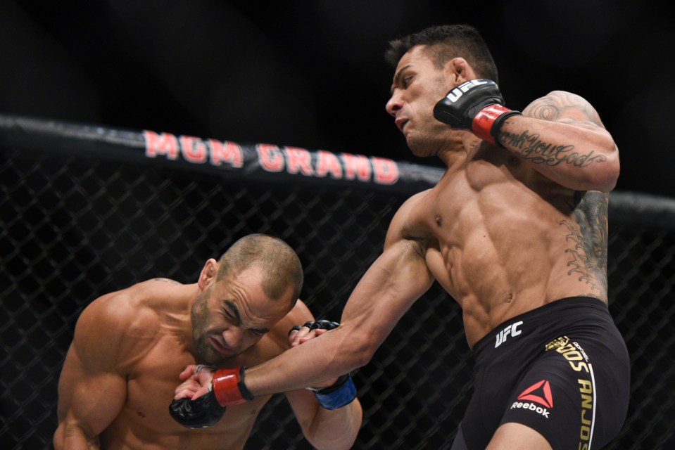 Early success: Rafael dos Anjos lands an uppercut on Eddie Alvarez