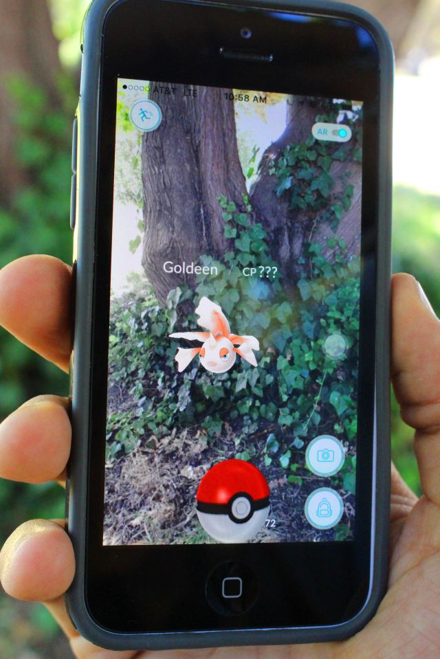 A Pokemon Go player takes aim on his smartphone