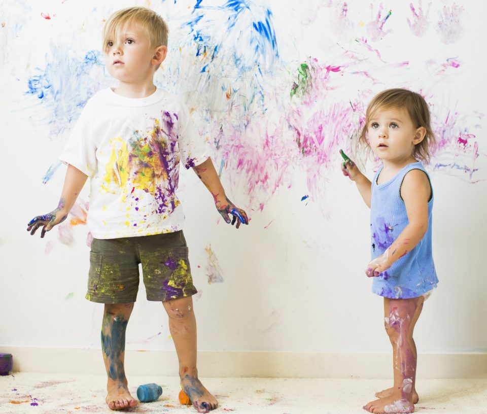 Children (2-3) painting on wall