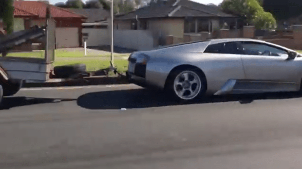 The Lamborghini is seen driving through a town in Australia