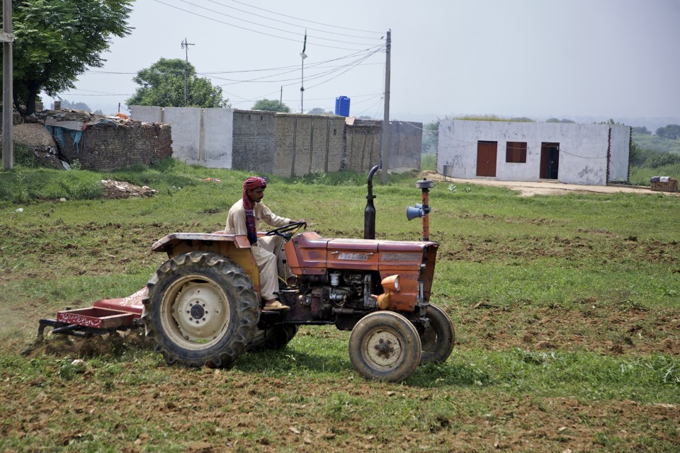  A farmer ploughs a field just behind the house of Amir in his village in 2010