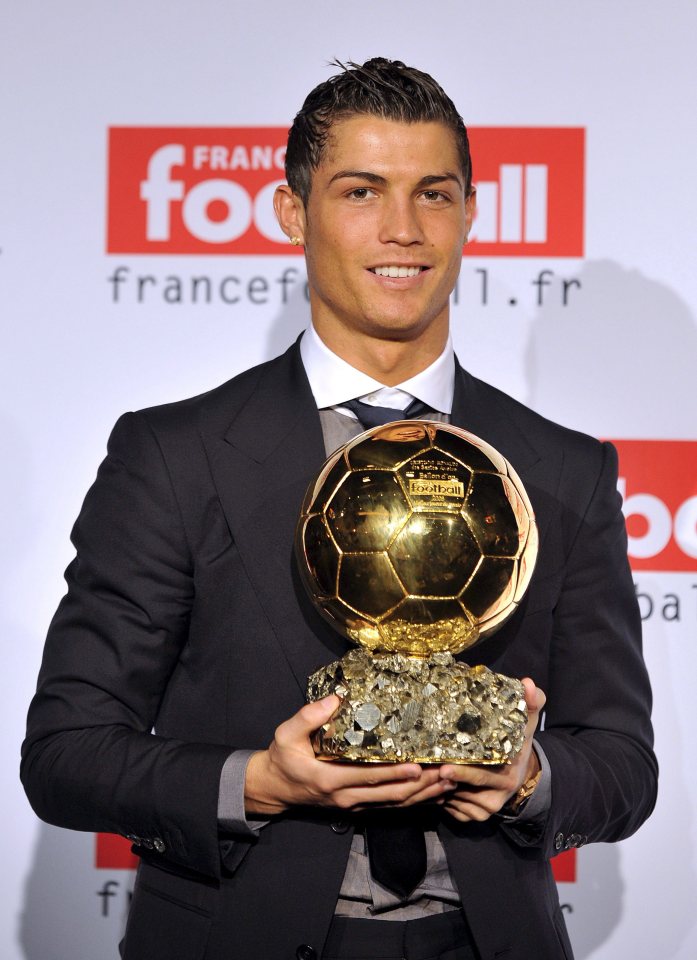  Cristiano Ronaldo proudly holds aloft his first Ballon d'Or, won in 2008