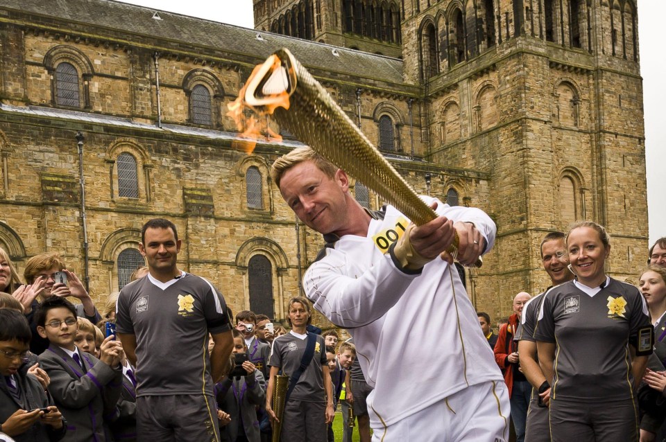  England cricketer Paul Collingwood with the Olympic flame in 2012