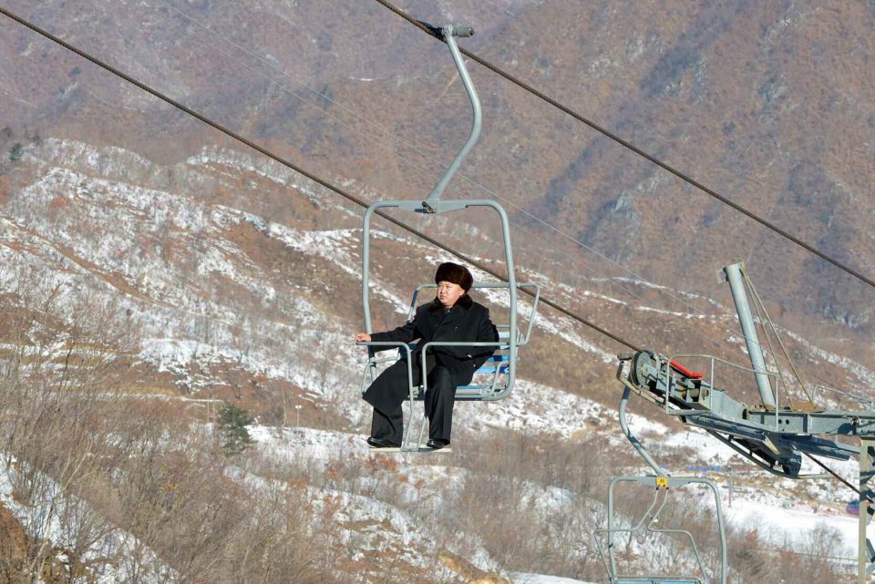  A lonely Un: Kim Jong rides the ski lift during his inspection tour of the ski resort in 2013