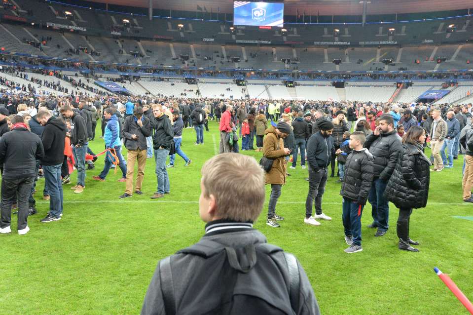  Spectators wait on the Stade de France pitch after the Paris attacks in November