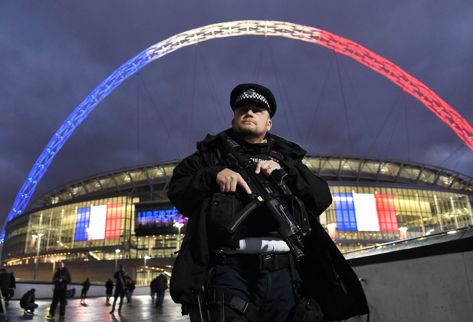 Stadium . . . armed cop guards Wembley after Paris horror