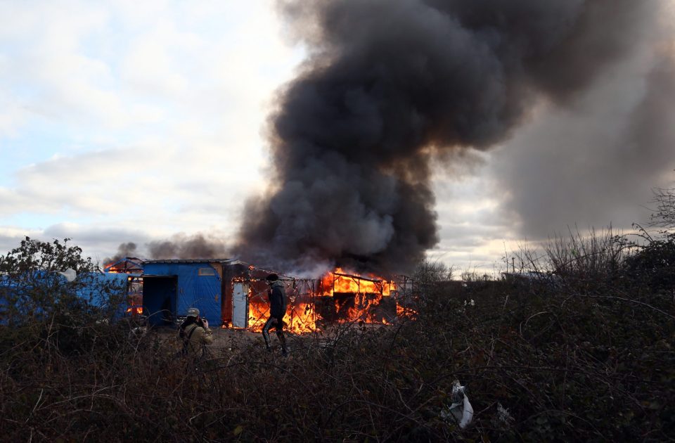 A tent burns during the destruction of the "Jungle" earlier this year