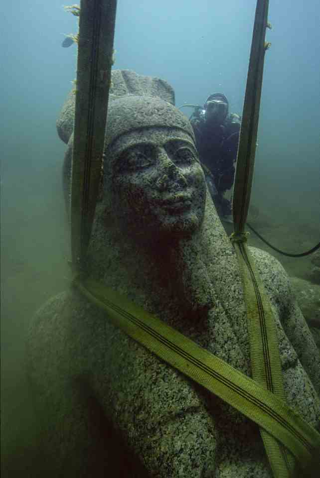 A colossal statue of red granite representing the god Hapy is pulled up from the seabed 