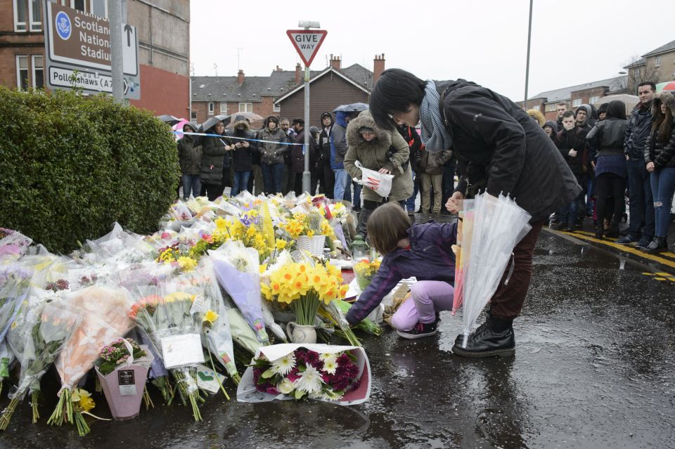  Hundred attended a vigil and left flowers outside Mr Shah's shop following his murder