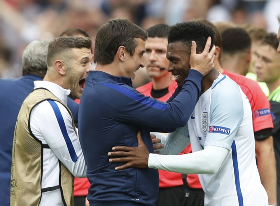 Gary Neville and Jack Wilshere celebrate with Daniel Sturridge after his late winner sealed victory over Wales