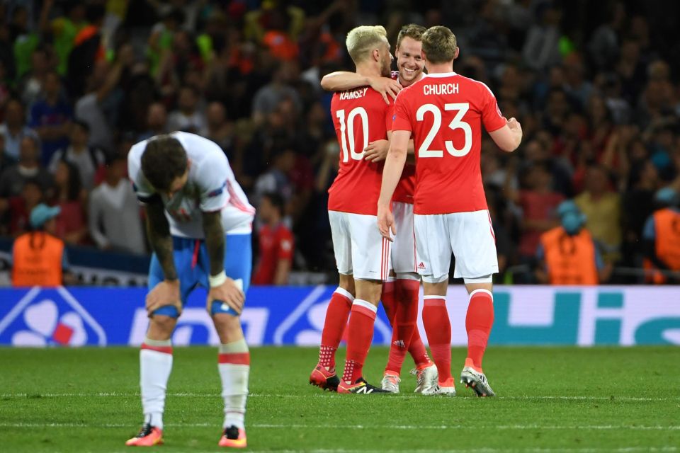 Wales players Wales' midfielder Aaron Ramsey, Wales' defender Chris Gunter and Wales' forward Simon Church celebrate their team's 3-0 win in the Euro 2016 group B football match between Russia and Wales at the Stadium Municipal in Toulouse on June 20, 2016. / AFP PHOTO / PASCAL GUYOTPASCAL GUYOT/AFP/Getty Images