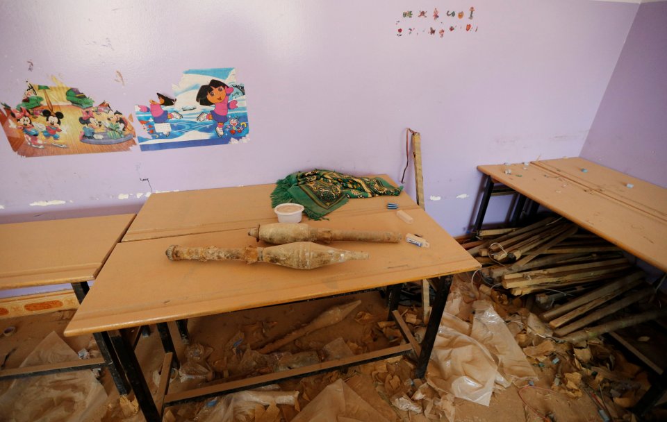  A school was left littered with rocket propelled grenades after ISIS fighters were beaten back and forced to flee the city