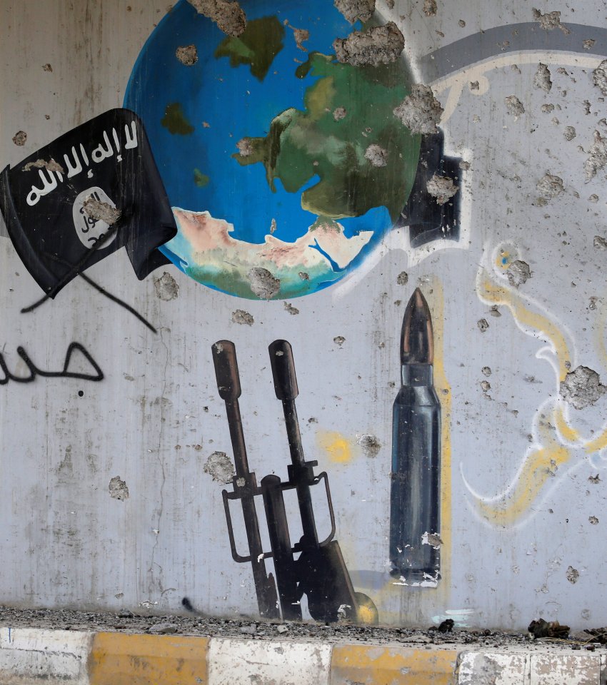  A school mural of a globe was added to by ISIS militants, who marked their flag over the globe to symbolise their bid for world domination